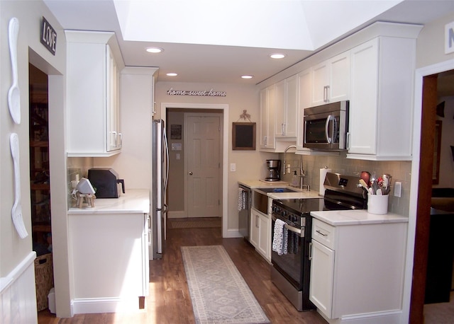 68 Palmer Dr, Sayville, NY 11782 - kitchen with stainless steel appliances, white cabinets, decorative backsplash, and recessed lighting