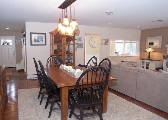 68 Palmer Dr, Sayville, NY 11782 - dining space featuring wood finished floors, baseboard heating, a chandelier, and recessed lighting