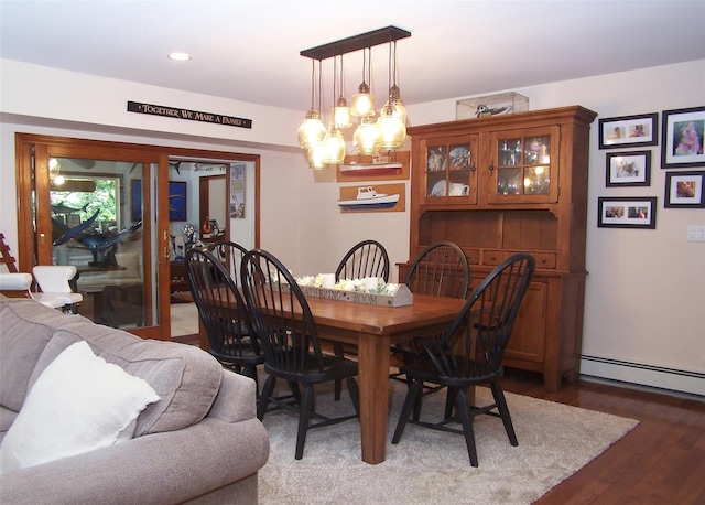 68 Palmer Dr, Sayville, NY 11782 - dining room featuring a baseboard heating unit, a chandelier, wood finished floors, and recessed lighting