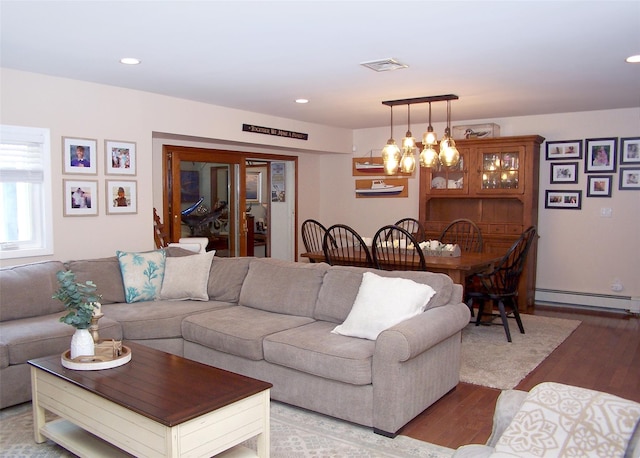 68 Palmer Dr, Sayville, NY 11782 - living area featuring a baseboard radiator, wood finished floors, a chandelier, and recessed lighting