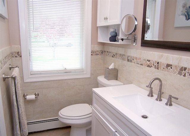 68 Palmer Dr, Sayville, NY 11782 - bathroom featuring baseboard heating, tile walls, vanity, and wainscoting