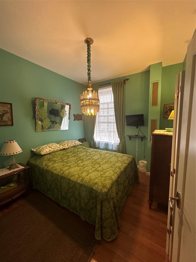 616 W 137th St Unit 1D, New York Manhattan, NY 10031 - bedroom with dark wood-type flooring and a chandelier