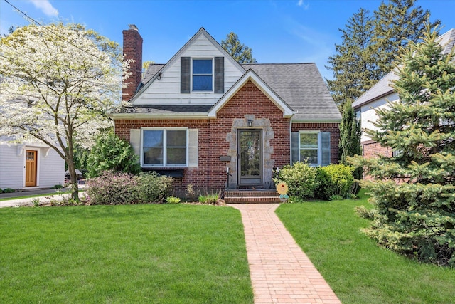 18 Hathaway Dr, Garden City, NY 11530 - view of front facade featuring a front lawn, brick siding, a chimney, and a shingled roof