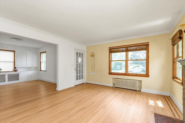 18 Hathaway Dr, Garden City, NY 11530 - unfurnished room featuring radiator heating unit, light wood-type flooring, and ornamental molding
