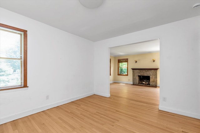 18 Hathaway Dr, Garden City, NY 11530 - unfurnished living room with light wood-style flooring and a fireplace with flush hearth