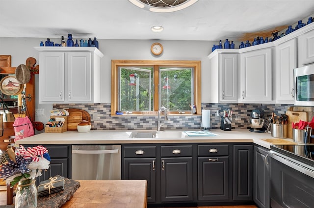 189 School House Rd, Middletown, NY 10940 - kitchen featuring stainless steel appliances, white cabinetry, decorative backsplash, and light countertops