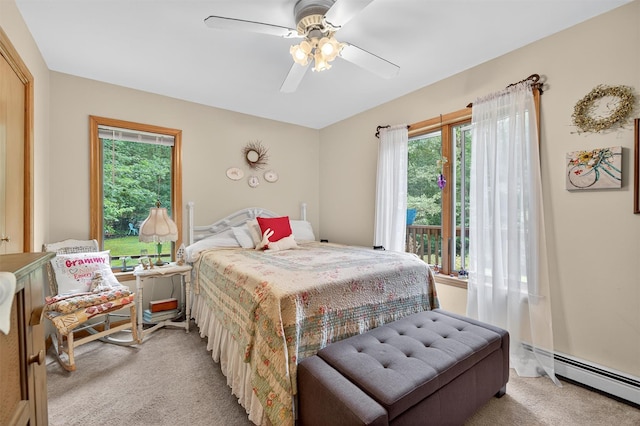 189 School House Rd, Middletown, NY 10940 - bedroom with light carpet, multiple windows, a baseboard heating unit, and a ceiling fan