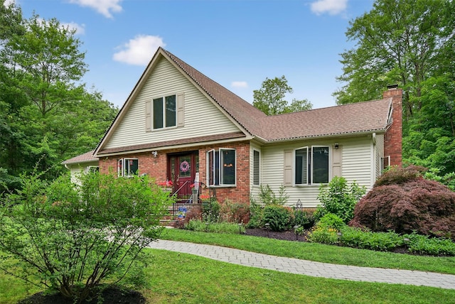 189 School House Rd, Middletown, NY 10940 - view of front of house featuring a chimney, a front lawn, brick siding, and a shingled roof