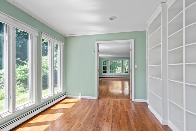 6 Beardsley Ln, Lloyd Harbor, NY 11743 - spare room with a baseboard heating unit, plenty of natural light, ornamental molding, wood finished floors, and baseboard heating