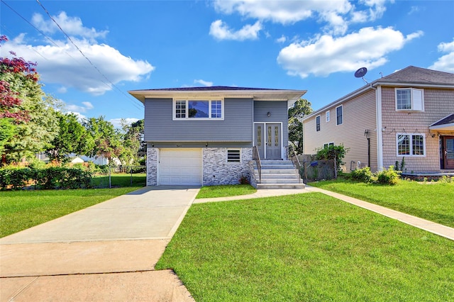 9 Rhodes Ln, West Hempstead, NY 11552 - view of front facade featuring driveway, stone siding, and an attached garage