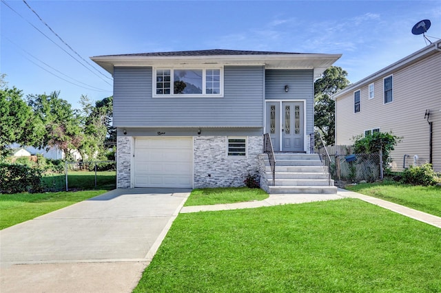 9 Rhodes Ln, West Hempstead, NY 11552 - split level home with concrete driveway, a garage, and stone siding