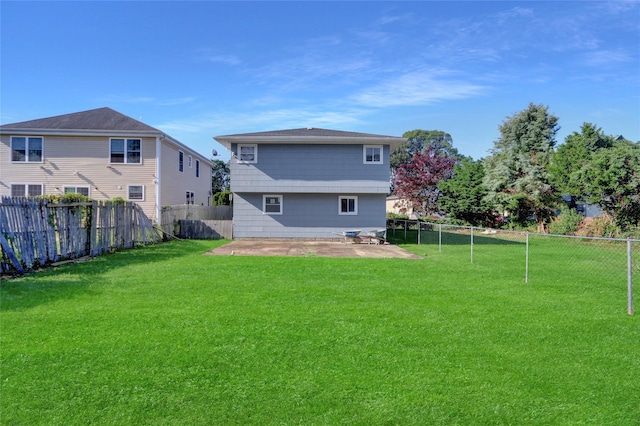 9 Rhodes Ln, West Hempstead, NY 11552 - rear view of property featuring a patio and a fenced backyard