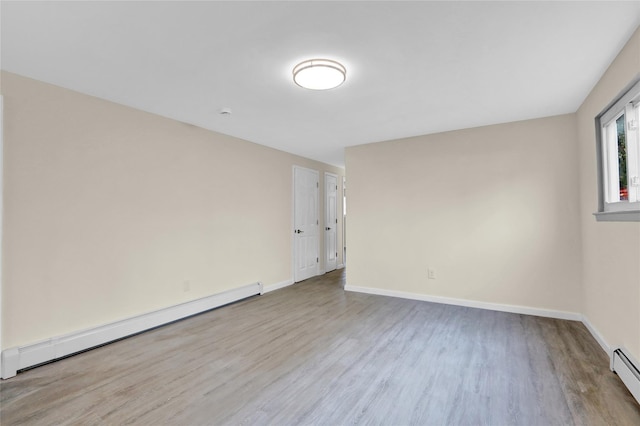 9 Rhodes Ln, West Hempstead, NY 11552 - unfurnished room featuring baseboard heating and wood finished floors