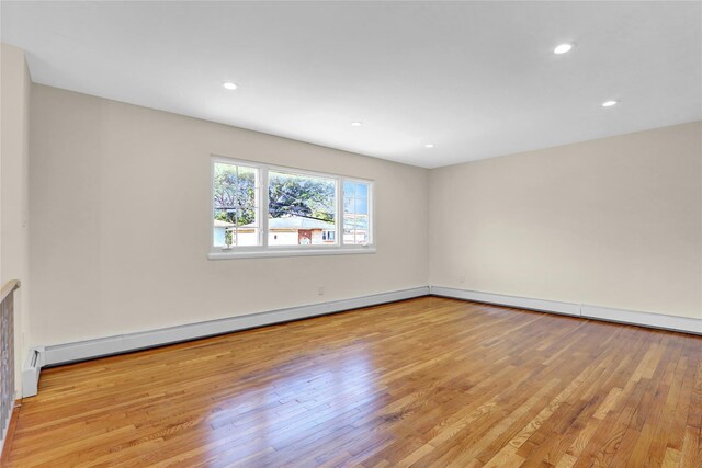 9 Rhodes Ln, West Hempstead, NY 11552 - empty room with light wood-type flooring, baseboard heating, and recessed lighting