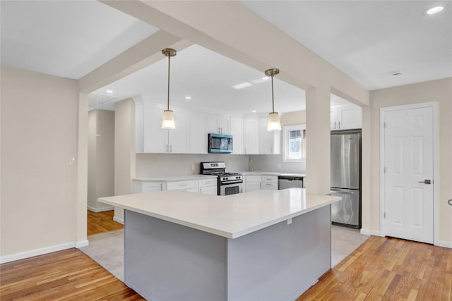 9 Rhodes Ln, West Hempstead, NY 11552 - kitchen with appliances with stainless steel finishes, light wood-style floors, white cabinetry, recessed lighting, and light countertops