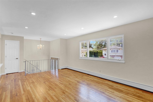 9 Rhodes Ln, West Hempstead, NY 11552 - unfurnished room featuring a baseboard radiator, wood finished floors, a chandelier, and recessed lighting