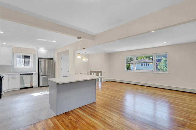 9 Rhodes Ln, West Hempstead, NY 11552 - kitchen with stainless steel appliances, a baseboard heating unit, white cabinets, light countertops, and recessed lighting