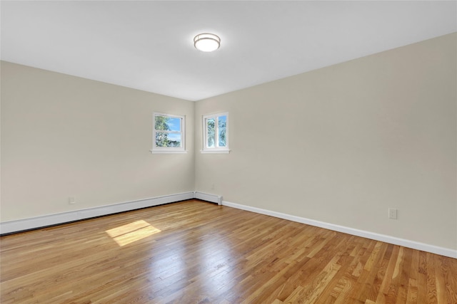 9 Rhodes Ln, West Hempstead, NY 11552 - unfurnished room with baseboard heating and wood finished floors