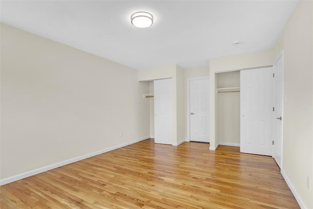 9 Rhodes Ln, West Hempstead, NY 11552 - unfurnished bedroom with two closets and light wood-style flooring