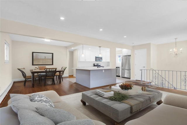 9 Rhodes Ln, West Hempstead, NY 11552 - living room with wood finished floors, recessed lighting, and a chandelier