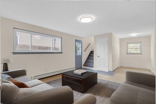 9 Rhodes Ln, West Hempstead, NY 11552 - living area with a baseboard heating unit, stairs, and healthy amount of natural light
