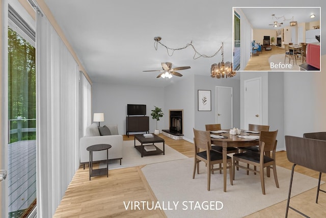 156 Creamery Rd Unit Tr20, Swan Lake, NY 12783 - dining room with wood finished floors, a chandelier, and a ceiling fan