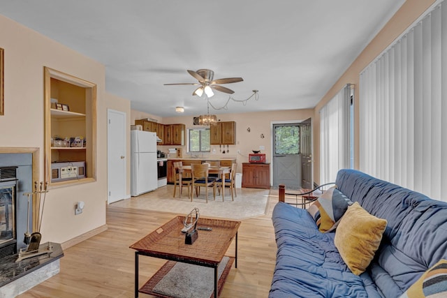 156 Creamery Rd Unit Tr20, Swan Lake, NY 12783 - living area featuring ceiling fan, light wood finished floors, built in shelves, and a fireplace with raised hearth