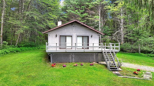 156 Creamery Rd Unit Tr20, Swan Lake, NY 12783 - view of front of property featuring a chimney, a front yard, a wooden deck, stairway, and a forest view