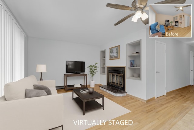 156 Creamery Rd Unit Tr20, Swan Lake, NY 12783 - living room with ceiling fan, built in shelves, light wood-style floors, a glass covered fireplace, and a baseboard radiator