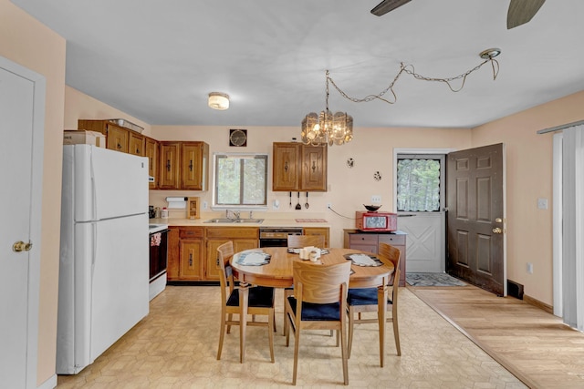 156 Creamery Rd Unit Tr20, Swan Lake, NY 12783 - kitchen featuring freestanding refrigerator, stove, brown cabinetry, light countertops, and a chandelier