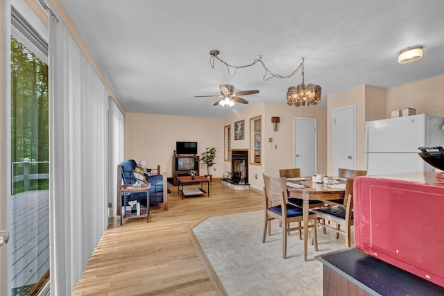 156 Creamery Rd Unit Tr20, Swan Lake, NY 12783 - dining space featuring a ceiling fan, light wood-style flooring, and a chandelier