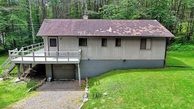 156 Creamery Rd Unit Tr20, Swan Lake, NY 12783 - view of front of home with a front yard, driveway, a deck, a garage, and a forest view