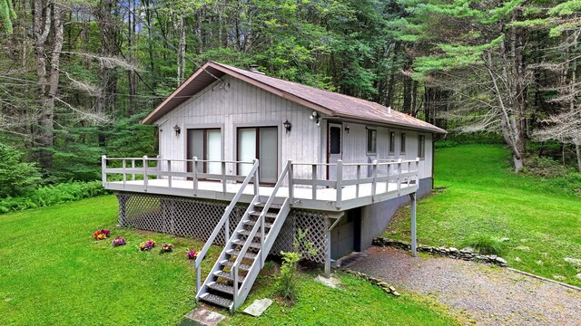 156 Creamery Rd Unit Tr20, Swan Lake, NY 12783 - view of front of house featuring a front lawn, a wooden deck, stairway, and a view of trees