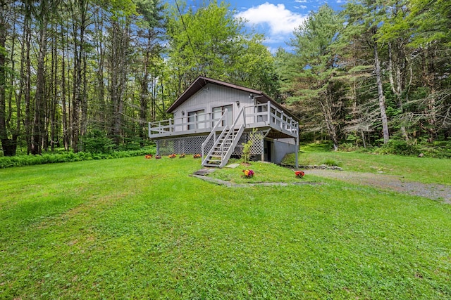 156 Creamery Rd Unit Tr20, Swan Lake, NY 12783 - view of side of property featuring a deck, a lawn, stairway, and a view of trees