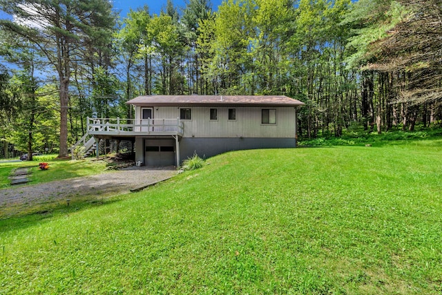 156 Creamery Rd Unit Tr20, Swan Lake, NY 12783 - back of property featuring gravel driveway, a garage, a wooden deck, a yard, and stairway