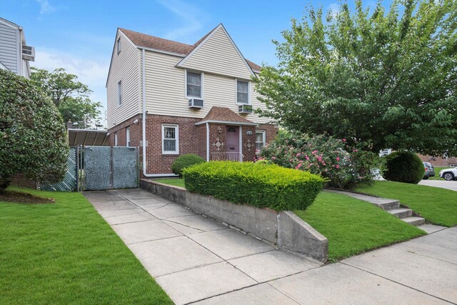 5802 201st St, Bayside, NY 11364 - view of front of property featuring brick siding, cooling unit, and a shingled roof