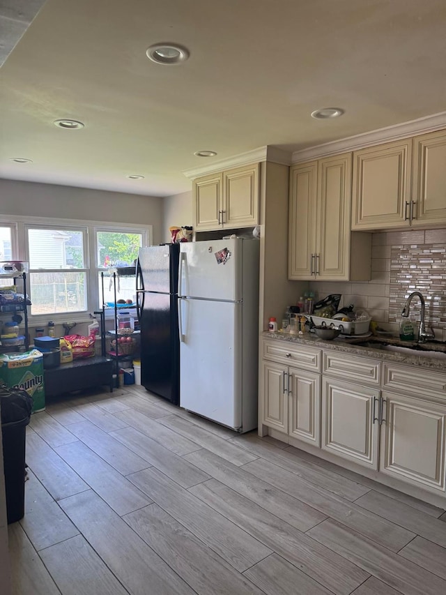 59 Ingraham Blvd, Hempstead, NY 11550 - kitchen with freestanding refrigerator, wood tiled floors, cream cabinetry, decorative backsplash, and recessed lighting