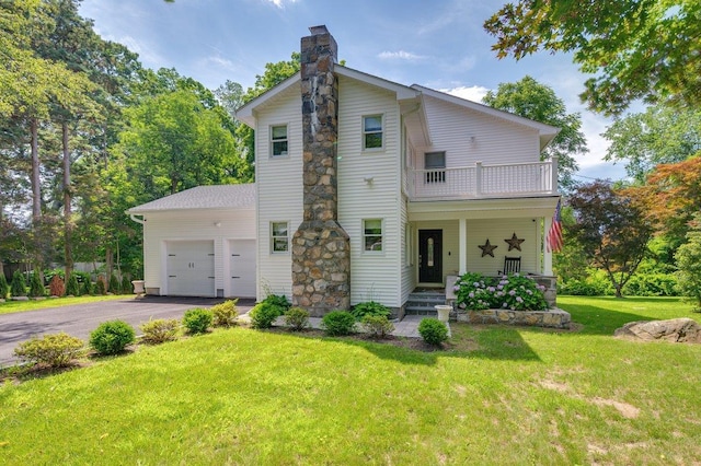 1299 Williams Dr, Shrub Oak, NY 10588 - view of front facade with a balcony, a chimney, driveway, a garage, and a front lawn