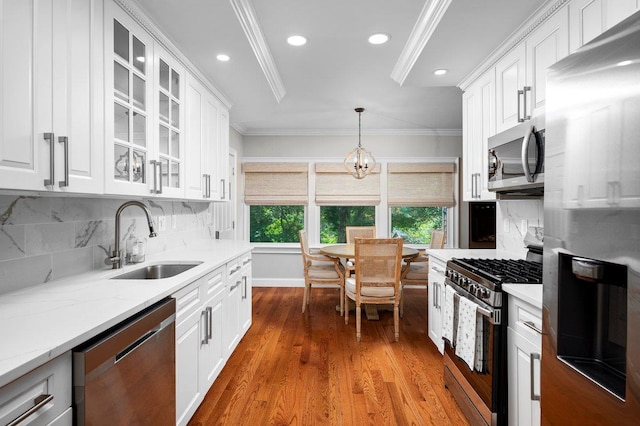 1299 Williams Dr, Shrub Oak, NY 10588 - kitchen featuring stainless steel appliances, ornamental molding, white cabinets, backsplash, and recessed lighting