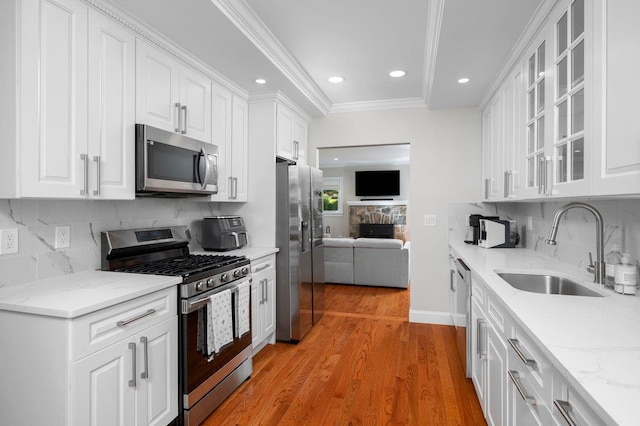 1299 Williams Dr, Shrub Oak, NY 10588 - kitchen featuring stainless steel appliances, white cabinetry, light wood-type flooring, glass insert cabinets, and recessed lighting