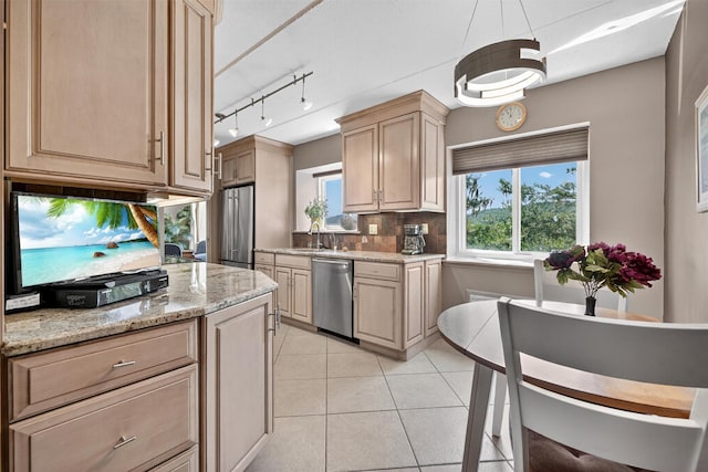 414 Benedict Ave Unit 5B, Tarrytown, NY 10591 - kitchen featuring appliances with stainless steel finishes, backsplash, light brown cabinetry, light tile patterned flooring, and light stone counters