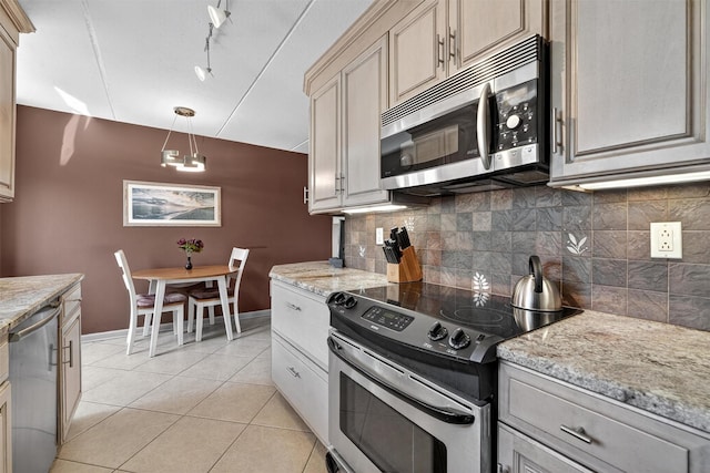 414 Benedict Ave Unit 5B, Tarrytown, NY 10591 - kitchen featuring stainless steel appliances, decorative backsplash, light tile patterned flooring, light stone counters, and track lighting