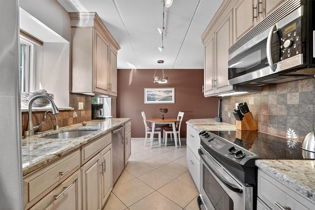 414 Benedict Ave Unit 5B, Tarrytown, NY 10591 - kitchen featuring stainless steel appliances, tasteful backsplash, light stone counters, and light tile patterned floors