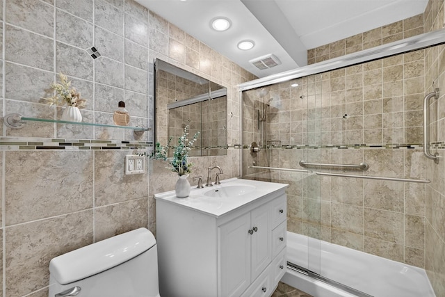 414 Benedict Ave Unit 5B, Tarrytown, NY 10591 - bathroom featuring tile walls, vanity, a shower stall, and recessed lighting