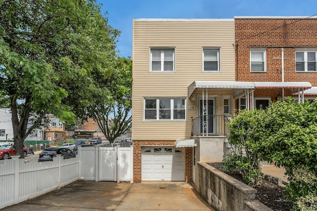 1138 Vincent Ave, Bronx, NY 10465 - view of front facade with brick siding, an attached garage, and driveway
