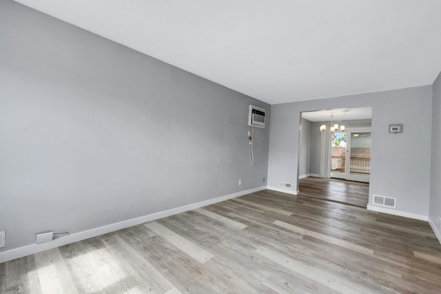 1138 Vincent Ave, Bronx, NY 10465 - spare room with a chandelier, wood finished floors, and an AC wall unit