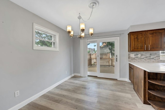 1138 Vincent Ave, Bronx, NY 10465 - unfurnished dining area featuring healthy amount of natural light, a chandelier, and light wood-type flooring