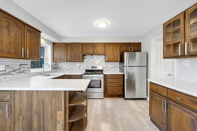 1138 Vincent Ave, Bronx, NY 10465 - kitchen featuring stainless steel appliances, backsplash, light countertops, and light wood finished floors