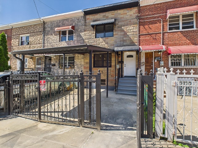 1310 E 223rd St, Bronx, NY 10466 - multi unit property featuring stone siding, a fenced front yard, and a gate