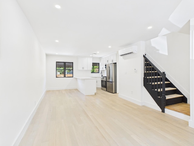 1310 E 223rd St, Bronx, NY 10466 - unfurnished living room featuring stairs, a wall unit AC, light wood-style flooring, and recessed lighting